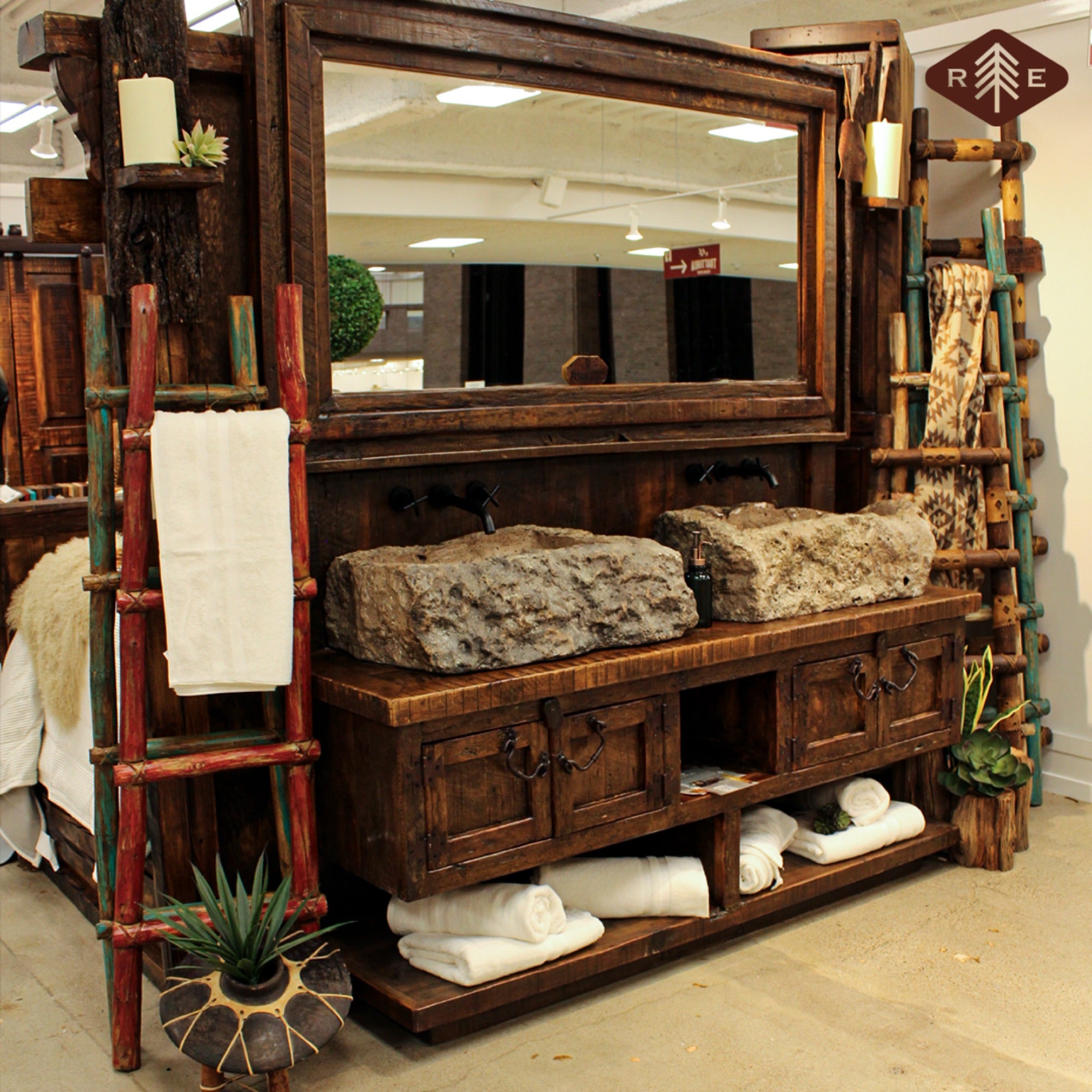 Rustic bathroom vanity with stone sinks and wooden cabinets