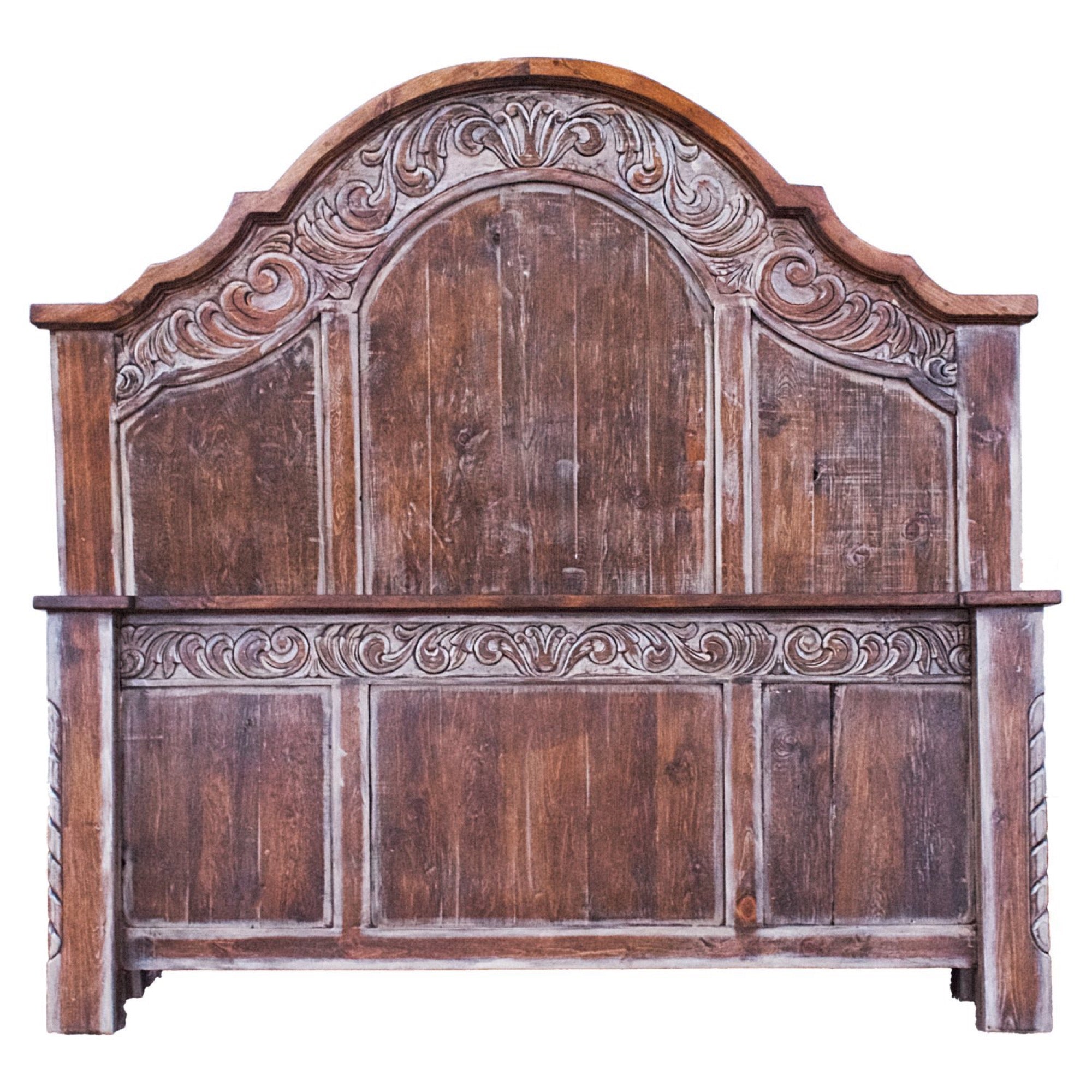 Rustic wooden headboard with carved floral details and an arched top