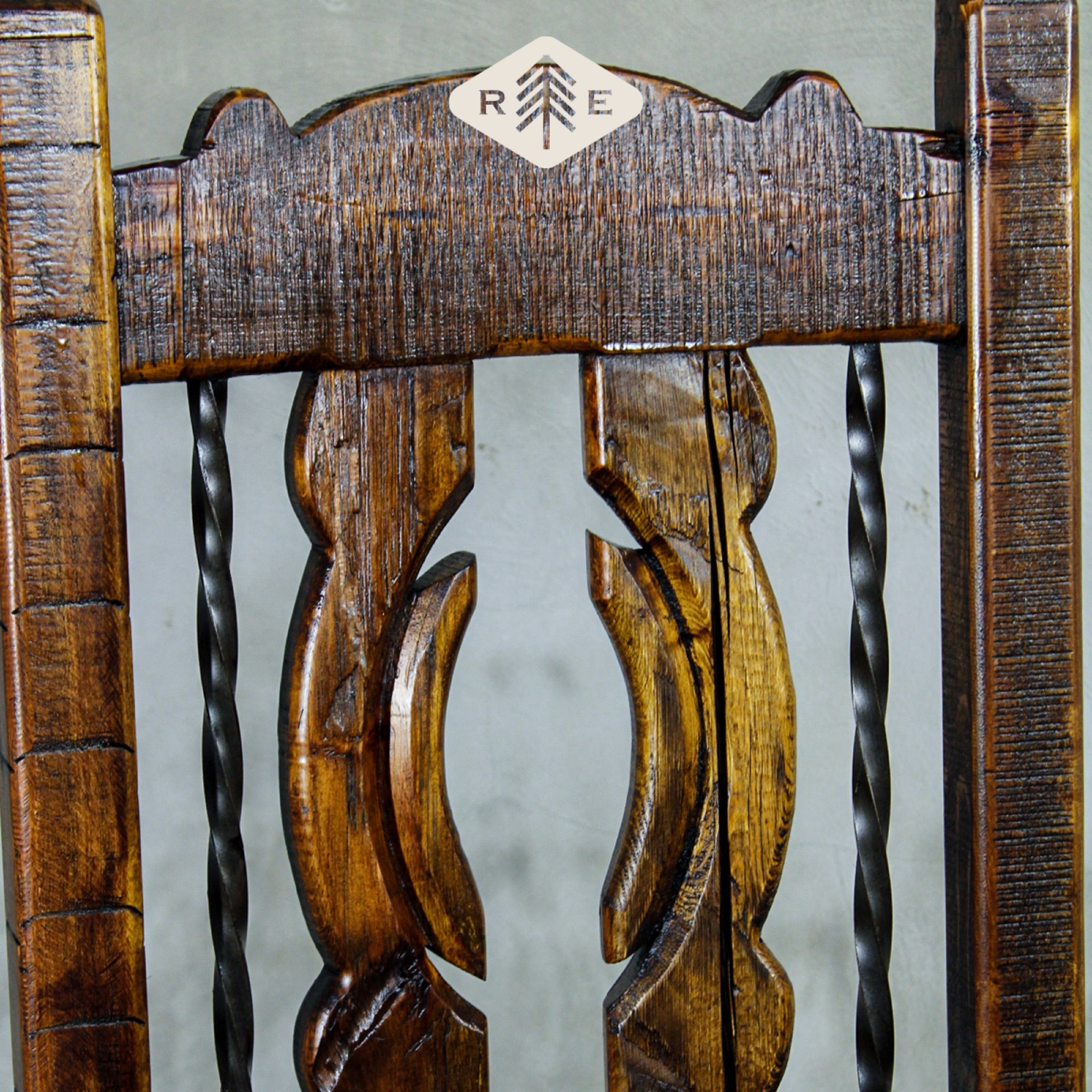 Close-up of an ornate wooden chair back with rustic design