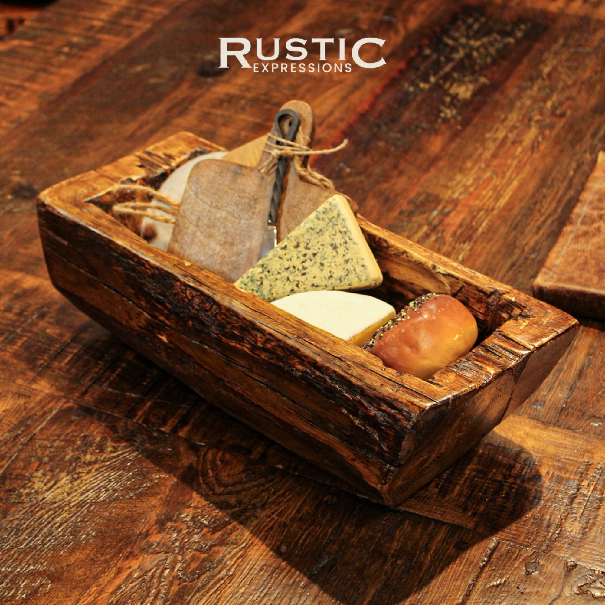 Rustic wooden serving tray with assorted cheeses